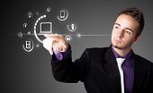 foto of businessmen  - Businessman pressing multimedia type of modern buttons with virtual background - JPG 