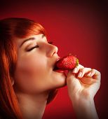 picture of bites  - Photo of seductive female eating strawberry - JPG 