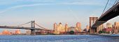 pic of bridge  - Manhattan Bridge and Brooklyn Bridge panorama over East River viewed from New York City Lower Manhattan waterfront at sunset - JPG 