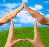 stock photo of home  - female hands showing home sign family house concept sky grass background - JPG 