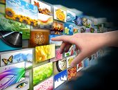 picture of  photo  - A hand is reaching out and touching a media technology gallery with image photos on a black background - JPG 