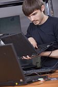pic of computer  - male computer technician installing new software on laptop - JPG 