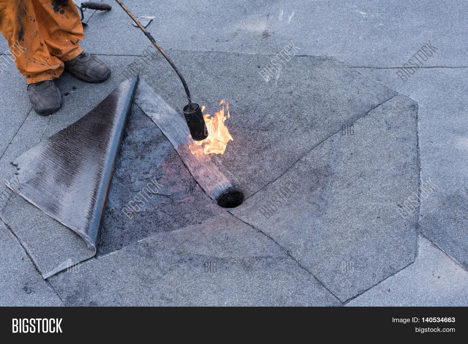 Roofer doing repair roof drain. Flat roof installation. Heating and