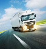 picture of tilting  - White truck on asphalt road under blue sky with clouds - JPG 