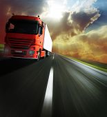 image of tilting  - Heavy truck on blurry asphalt road under sunlight - JPG 