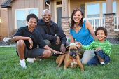 picture of dog  - Family with dog in grass by home - JPG 