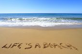 stock photo of beach  - ?Life is a beach? written on golden sandy beach - JPG 