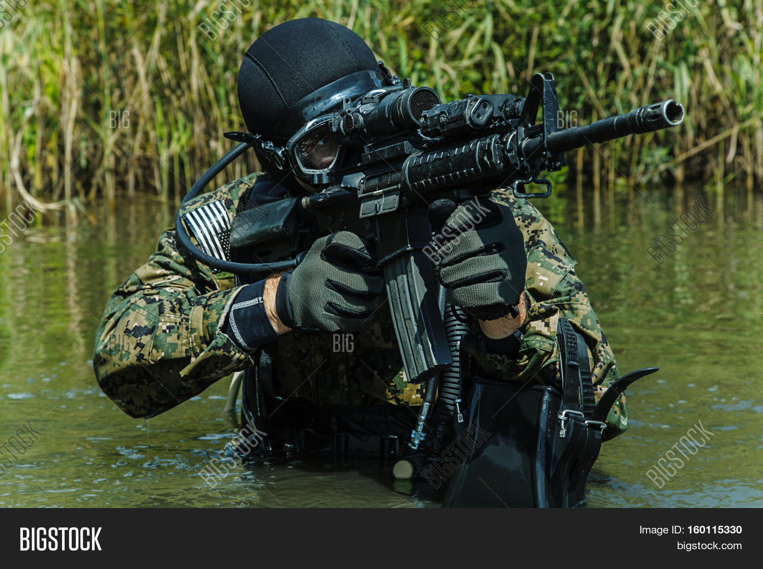 Navy SEAL frogman with complete diving gear and weapons in the water
