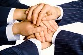 stock photo of business people  - Photo of human hands on top of each other isolated on a white background - JPG 