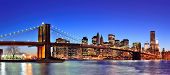 picture of bridge  - Brooklyn bridge with New York City Manhattan downtown skyline panorama at dusk illuminated over East River with blue clear sky - JPG 