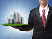 stock photo of construction  - business man and real estate in hand use for property land management and building construction theme - JPG 