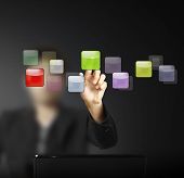 image of future technology  - hand pushing on a touch screen interface - JPG 