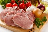 foto of animals  - Raw pork on cutting board and vegetables - JPG 