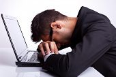 pic of pressure  - Tired business man with head and hands down on laptop - JPG 