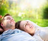 stock photo of health  - Happy Smiling Couple Relaxing on Green Grass - JPG 