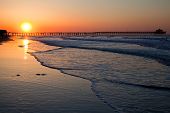 picture of beach  - A brilliant yellow sun rises over the pier at North Myrtle Beach - JPG 