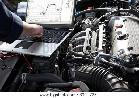 Picture or Photo of Professional car mechanic working in auto repair service.