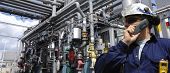 stock photo of http  - oil refinery worker with pipelines in background - JPG 