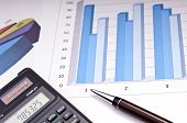 stock photo of finance  - Graphs calculator and paper statements for finance concept - JPG 