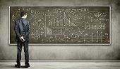 pic of science  - Business person standing against the blackboard with a lot of data written on it - JPG 