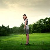 picture of golf  - Portrait of an elegant woman playing golf on a green woman - JPG 