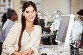 foto of industrial  - Woman Working At Desk In Busy Creative Office - JPG 