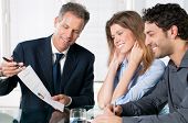 foto of meeting  - Happy young couple discussing with a financial agent their new investment - JPG 