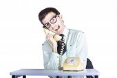 foto of telemarketing  - Young funny telemarketing businessman sitting at table with retro telephone annoying call center clerk concept white background - JPG 