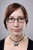image of normal  - Average looking nerdy girl with spectacles in studio - JPG 