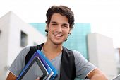 foto of buildings  - Cheerful student standing outside college building - JPG 