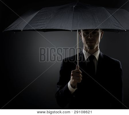 Picture or Photo of Portrait the beautiful man in black costume special-service agent or body guard