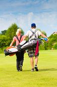 pic of golf  - Young sportive couple playing golf on a golf course - JPG 