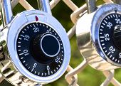 picture of locking  - This photo is a close up of two locks hanging on a chain link fence - JPG 