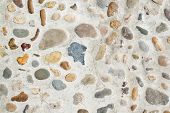 stock photo of embed  - Stones of various sizes and colors embedded in concrete - JPG 