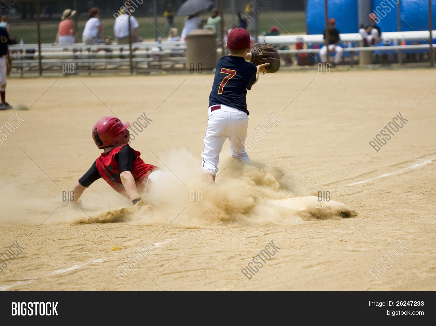 Little league baseball player sliding into third base Stock Photo