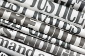 stock photo of newspaper  - Newspaper headlines side on in a stack of daily newspapers - JPG 