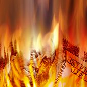 pic of money  - Burning American money with Benjamin Franklins face appearing on fire on a one hundred dollar bill - JPG 