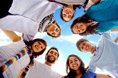 foto of blue sky  - group of happy friends smiling with heads together outdoors with a blue sky in the background - JPG 