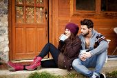 foto of outdoor  - Young couple having breakfast in a romantic cabin outdoors in winter - JPG 