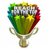 picture of competition  - Reach for the Top words in fireworks and colorful stars shooting out of a gold trophy symbolizing winning a competition or game - JPG 
