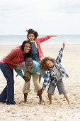 pic of family  - Happy family playing on beach - JPG 