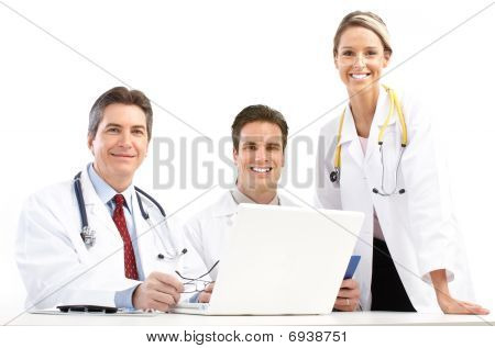 Picture or Photo of Smiling medical doctors with stethoscopes and laptop. Isolated over white background