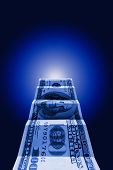 stock photo of blue  - Hundred dollars on a dark blue art background - JPG 