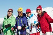 stock photo of group  - Group Of Middle Aged Couples On Ski Holiday In Mountains - JPG 