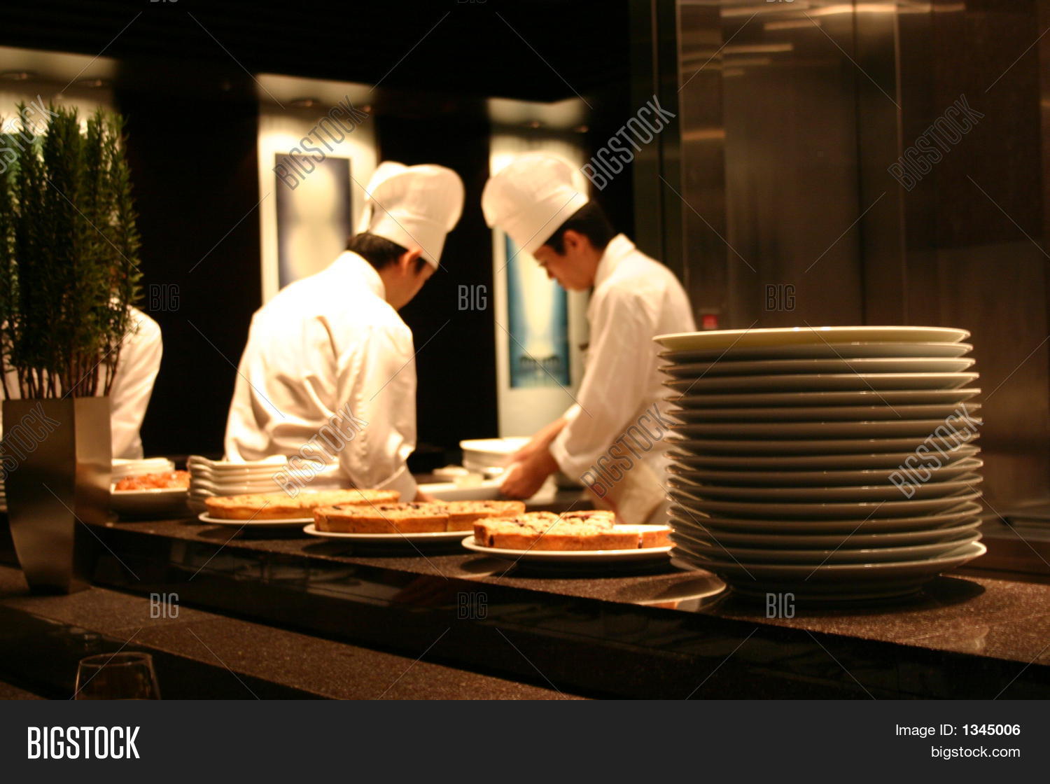 Busy Restaurant Kitchen two chefs working in a busy restaurant kitchen stock photo & stock Busy Restaurant Kitchen two chefs working in a busy restaurant kitchen stock photo & stock