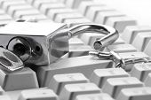 image of security  - Computer  keyboard secured with chain and padlock - JPG 