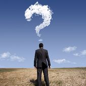 foto of mind  - businessman standing alone at the field with a lot of questions in his mind - JPG 