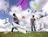 picture of surreal  - Teenager students outside protecting there heads from a rain of books - JPG 