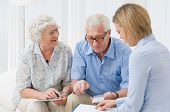 picture of investment  - Retired old couple planning their investments with a financial consultant - JPG 