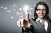 picture of future technology  - Businesswoman in suit pressing social media icon - JPG 